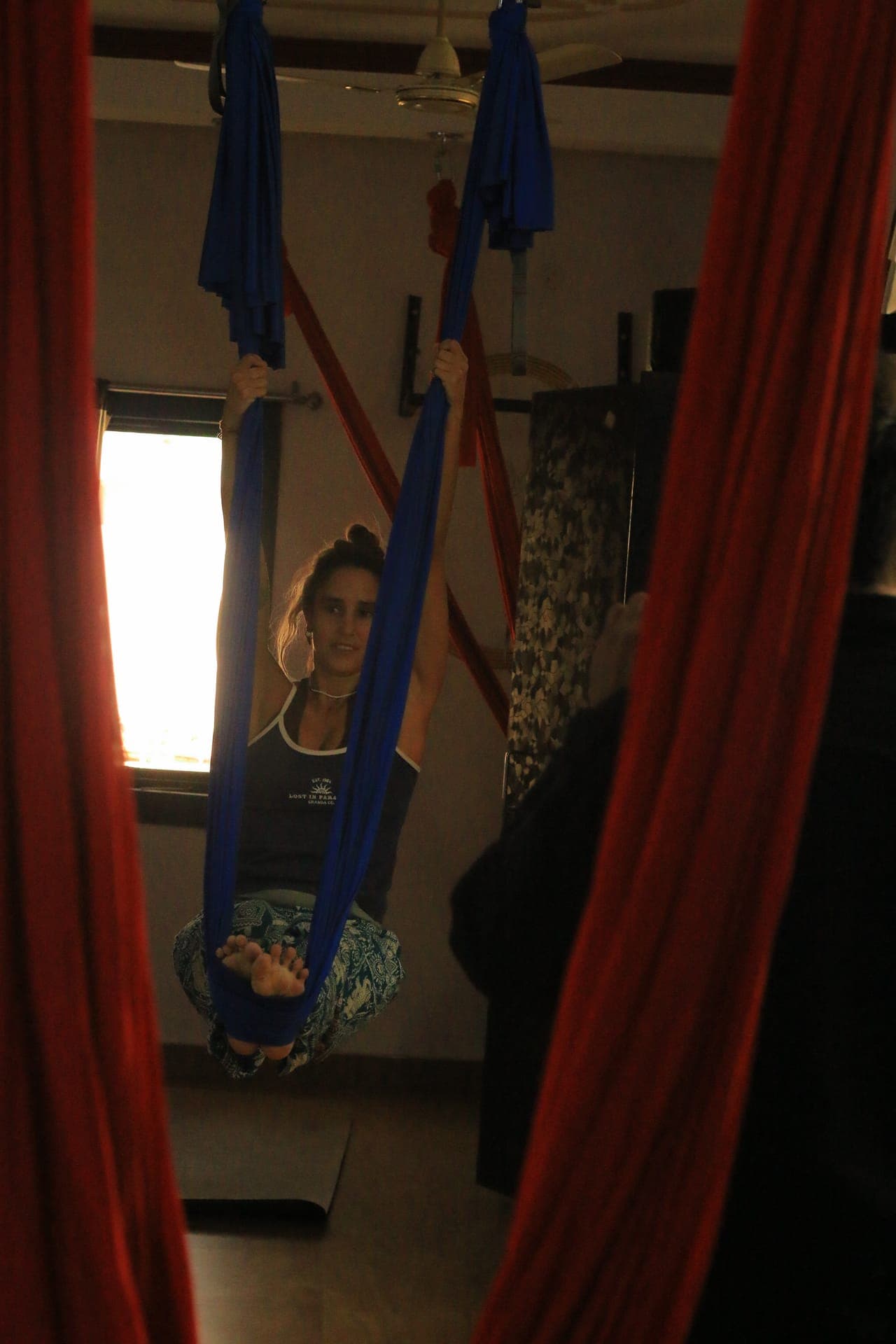 Student in aerial yoga cocoon