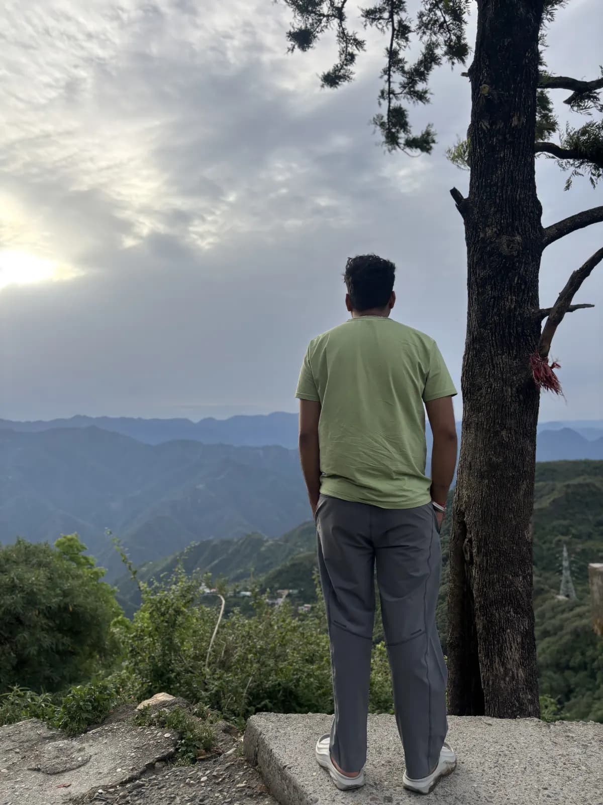 Student looking out across the Himalayan foothills from a hilltop viewpoint near Rishikesh