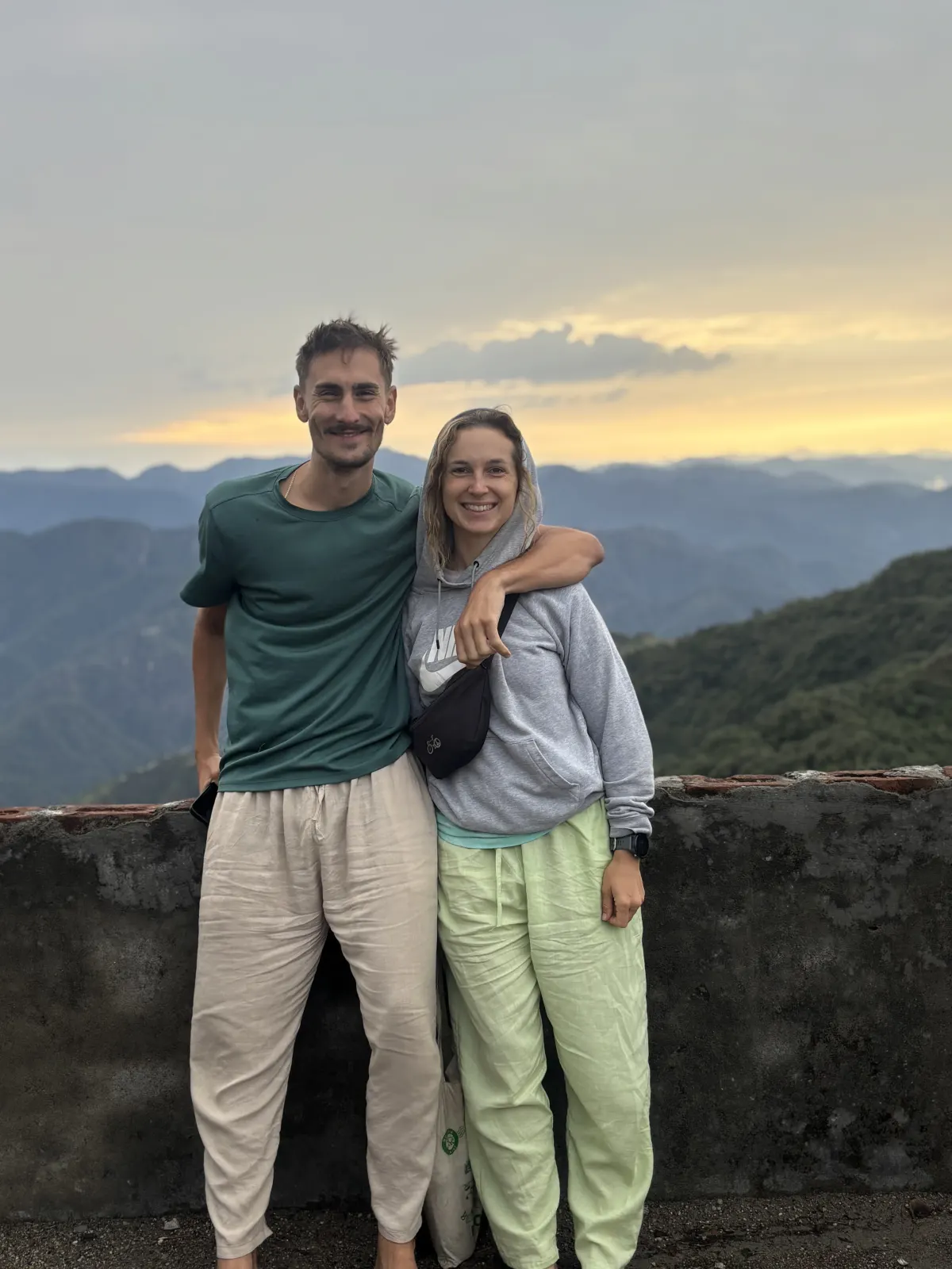 Two yoga students at a mountain sunset viewpoint above Rishikesh