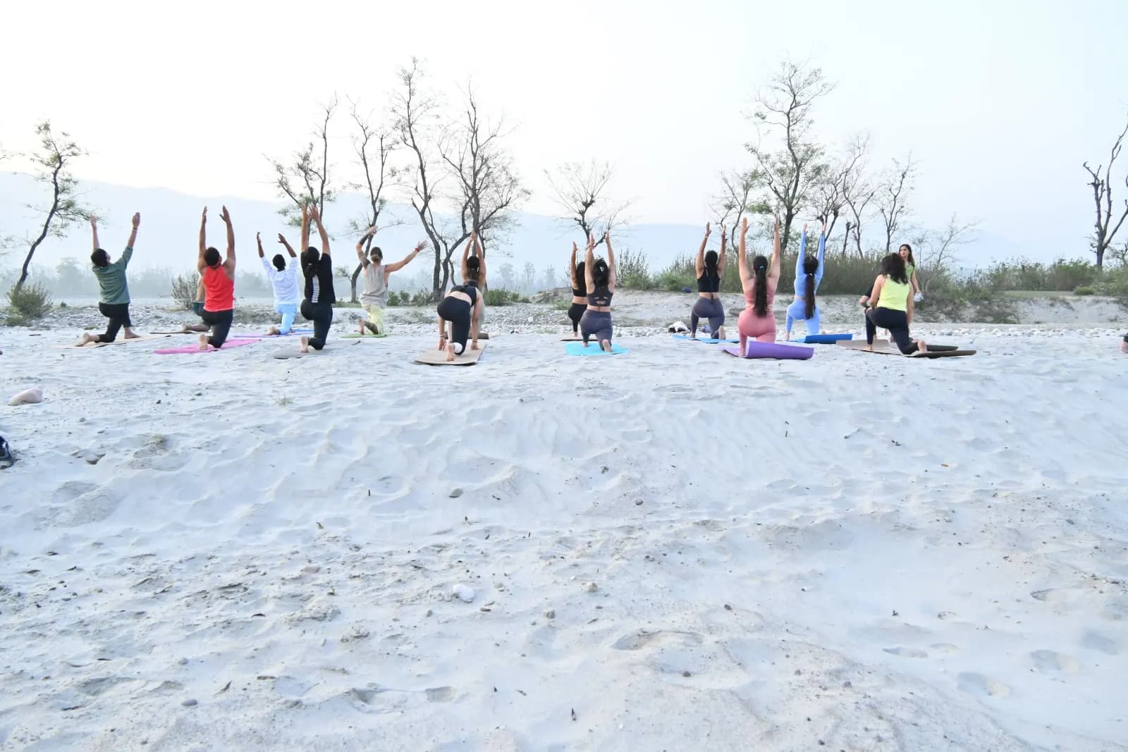 Morning yoga class on the white-sand Ganga beach in Rishikesh