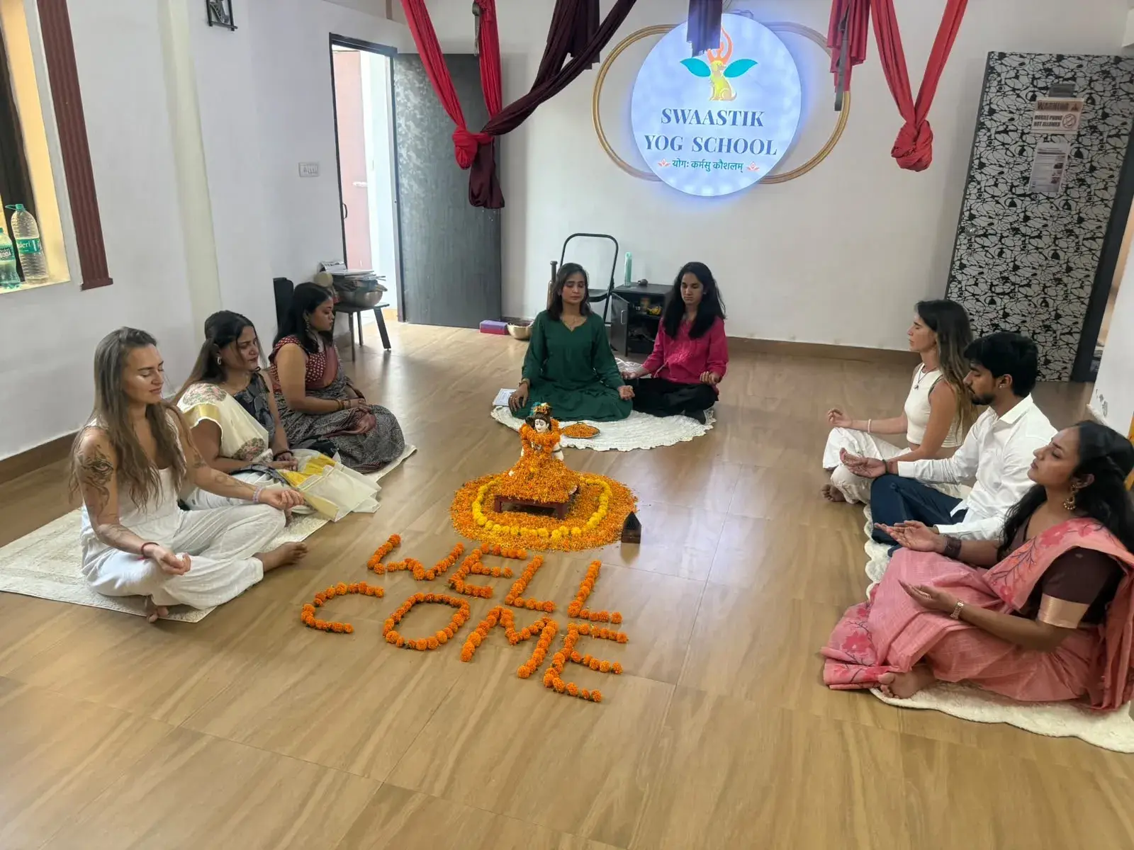 500 hour yoga teacher training students seated in a welcome meditation circle at Swaastik Yog School, Rishikesh
