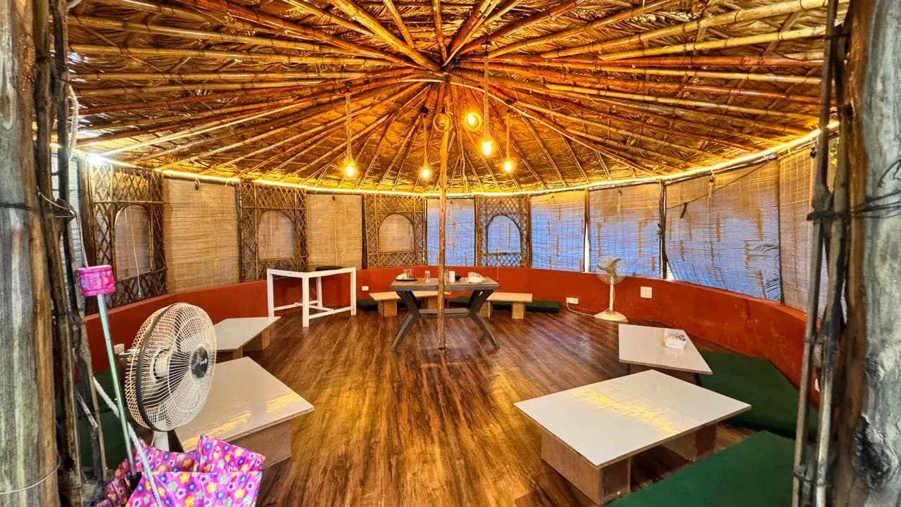 Round bamboo community and dining hall with string lights at Swaastik Yog School's Tapovan campus