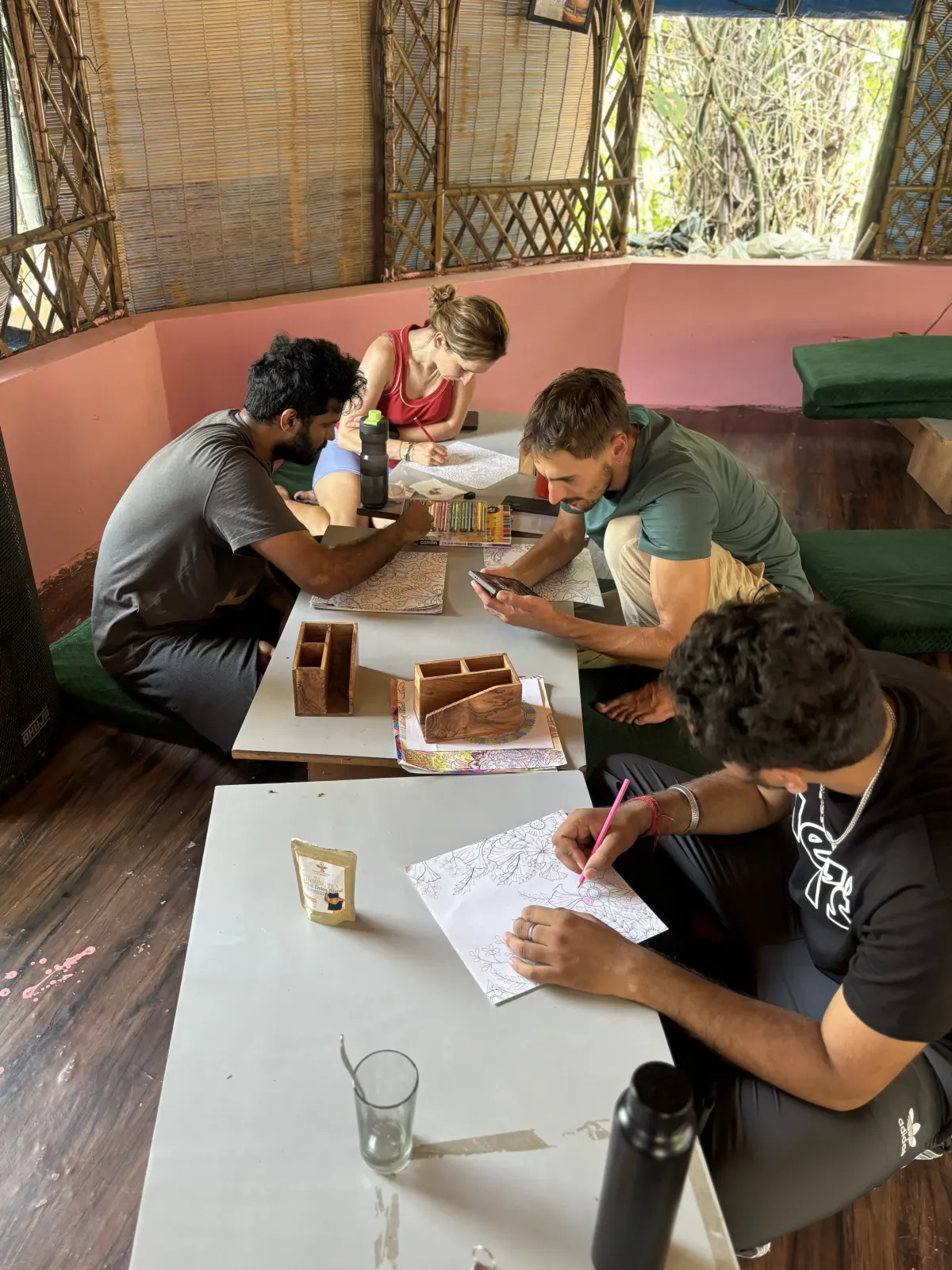 Teacher training students working together at the study tables between classes at Swaastik Yog School, Rishikesh