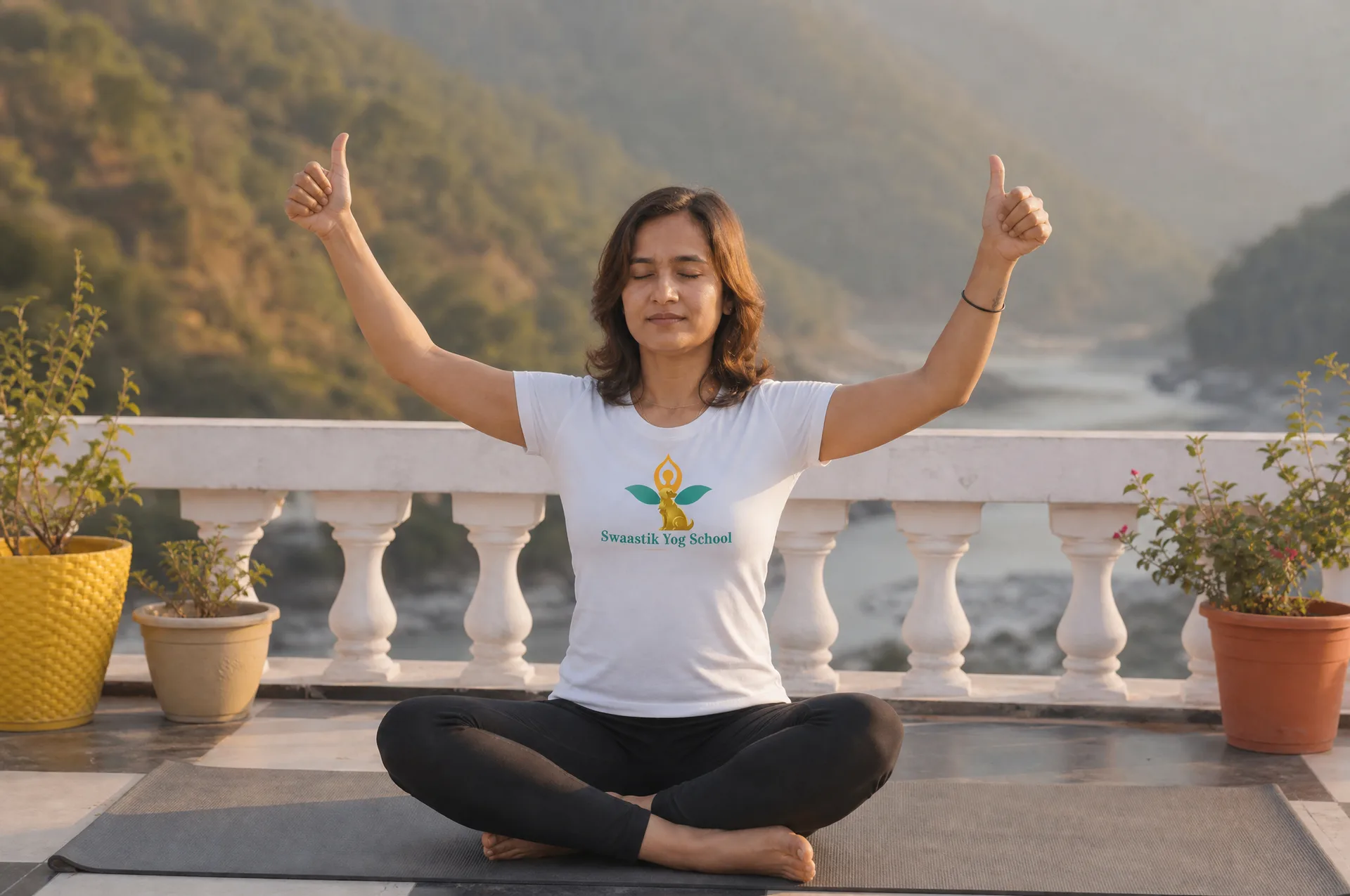 Mayuri practicing seated kundalini breathwork with arms raised on a Himalayan rooftop shala in Rishikesh