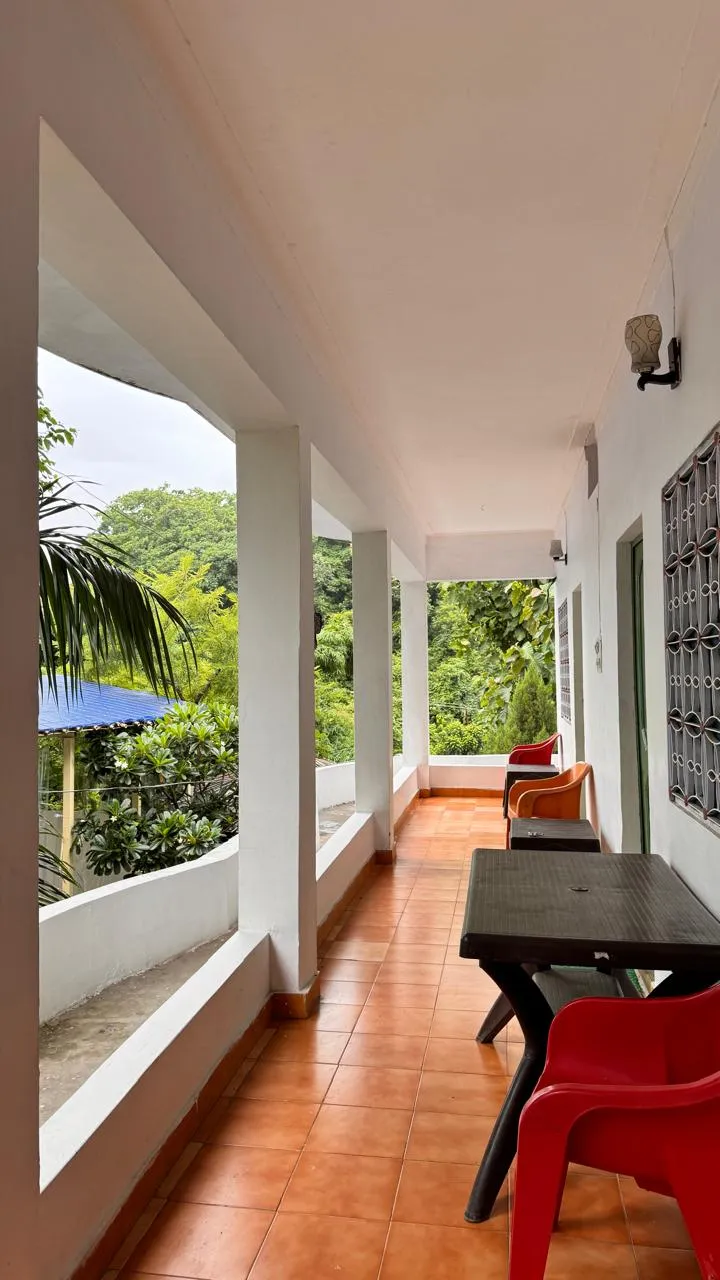 Open veranda with jungle-green valley view at a yoga school campus in Tapovan, Rishikesh